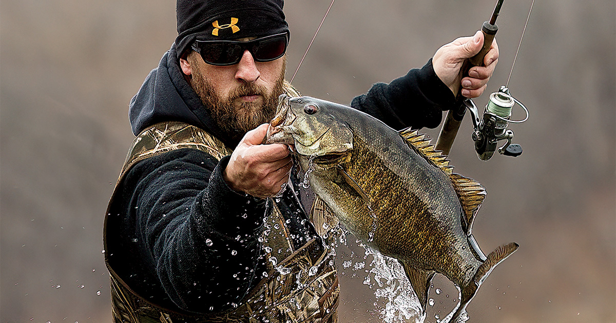 Angler with smallmouth bass. Photo by Tom Martineau/WildFrontImages.com